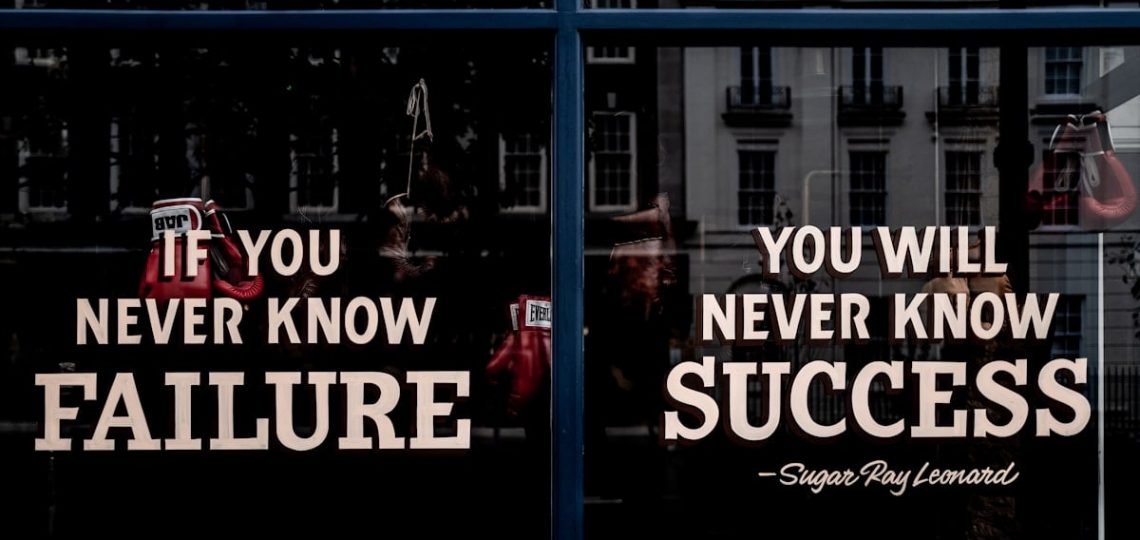 Motivational sign in the window of a boxing gym.