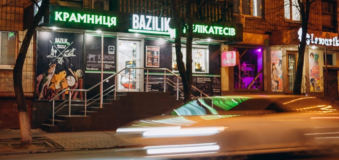 cars parked in front of store during night time
